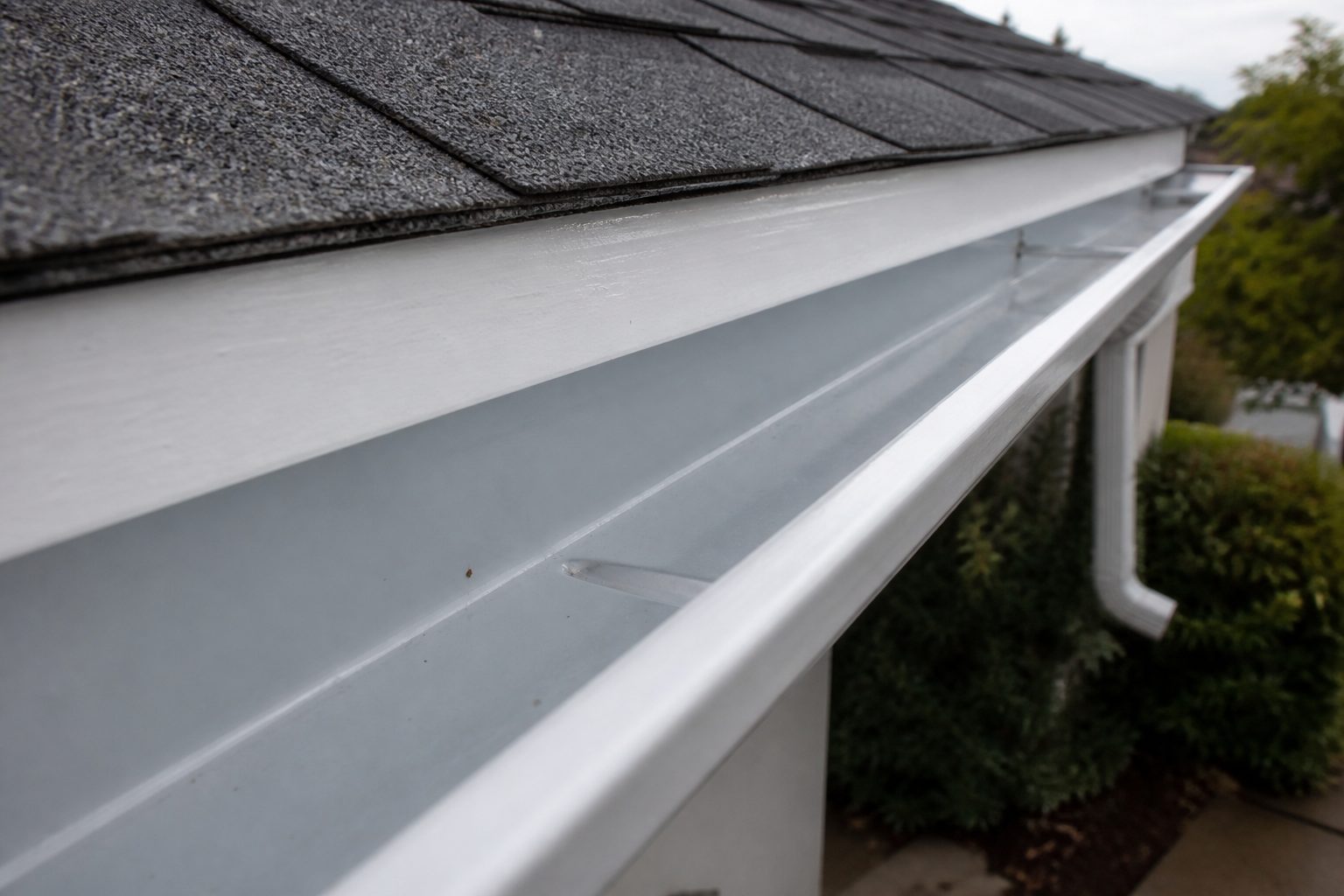 Clean rain gutter along the eave after a cleaning.